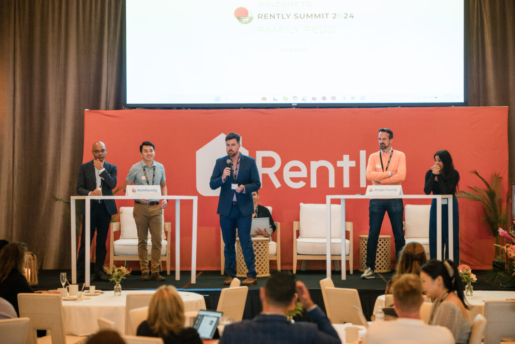 Rently summit attendees play family feud style game on stage