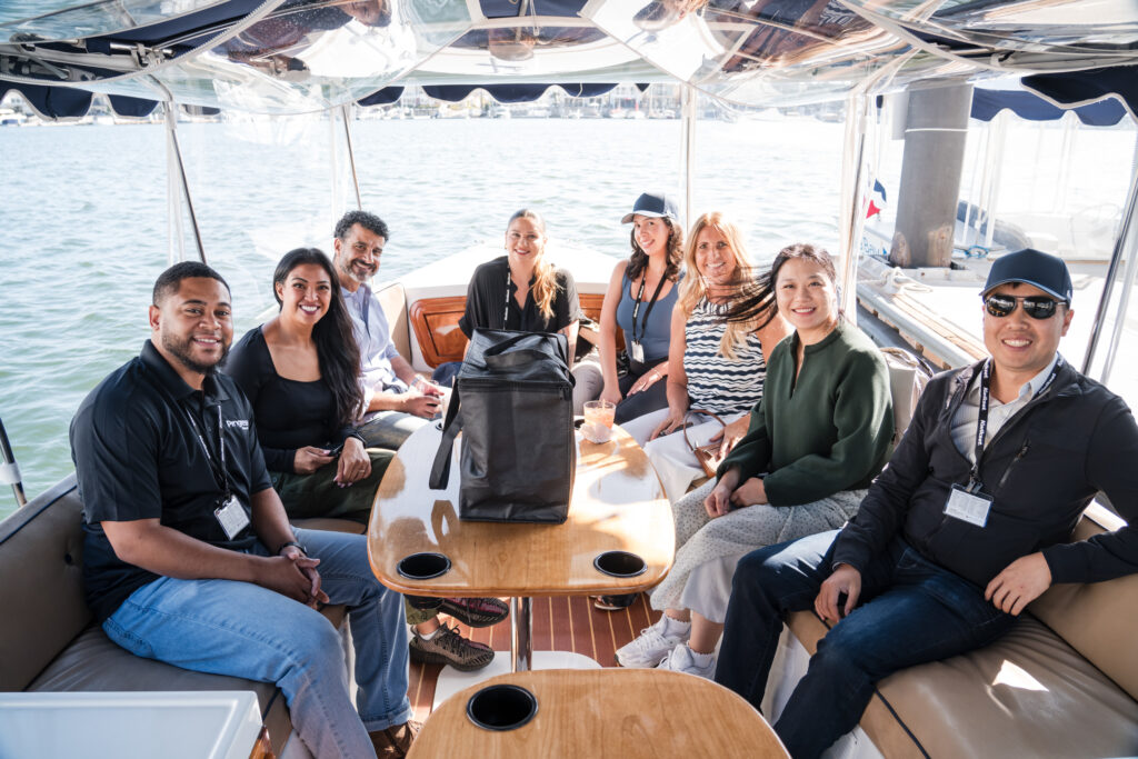 A group of the Rently Summit 2024 attendees enjoy a boat ride
