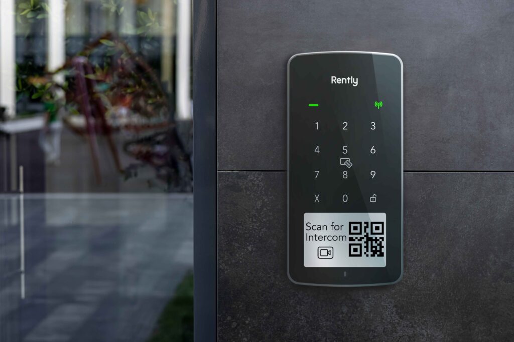 Photo of the Rently Access Panel with Intercom mounted on a wall beside a glass door