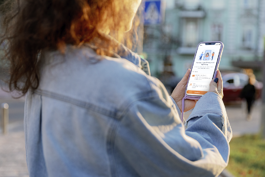 woman looking at her phone going through Rently's ID verification flow