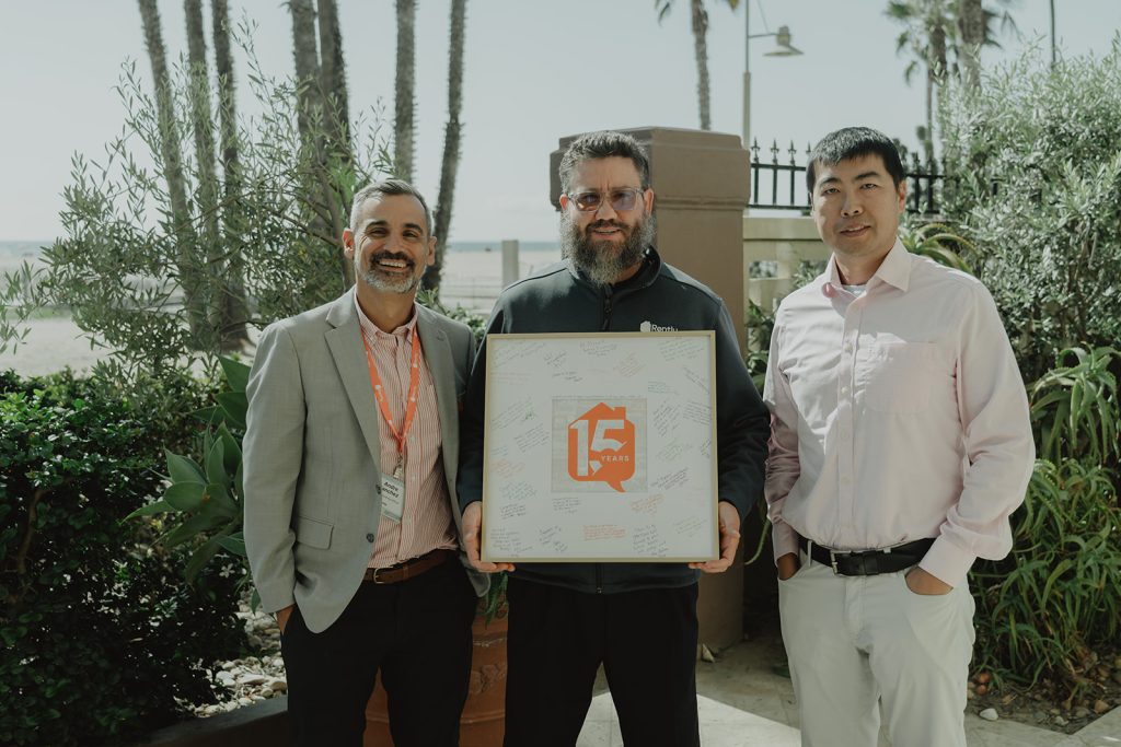 Merrick, Clark, and Andre holding a signed photo frame